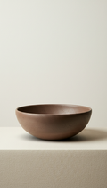 Espresso clay serving bowl, Default angle: slightly elevated three-quarter view to showcase silhouette and tactile finish....