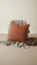 Terracotta throw pillow, Capture textiles in a 3/4 angle to highlight texture and craftsmanship. Use a simple background...