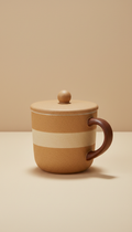 Wheat mug with lid, use a 3/4 angle to highlight the mug's shape and ergonomic design. Place the mug on a neutral,...